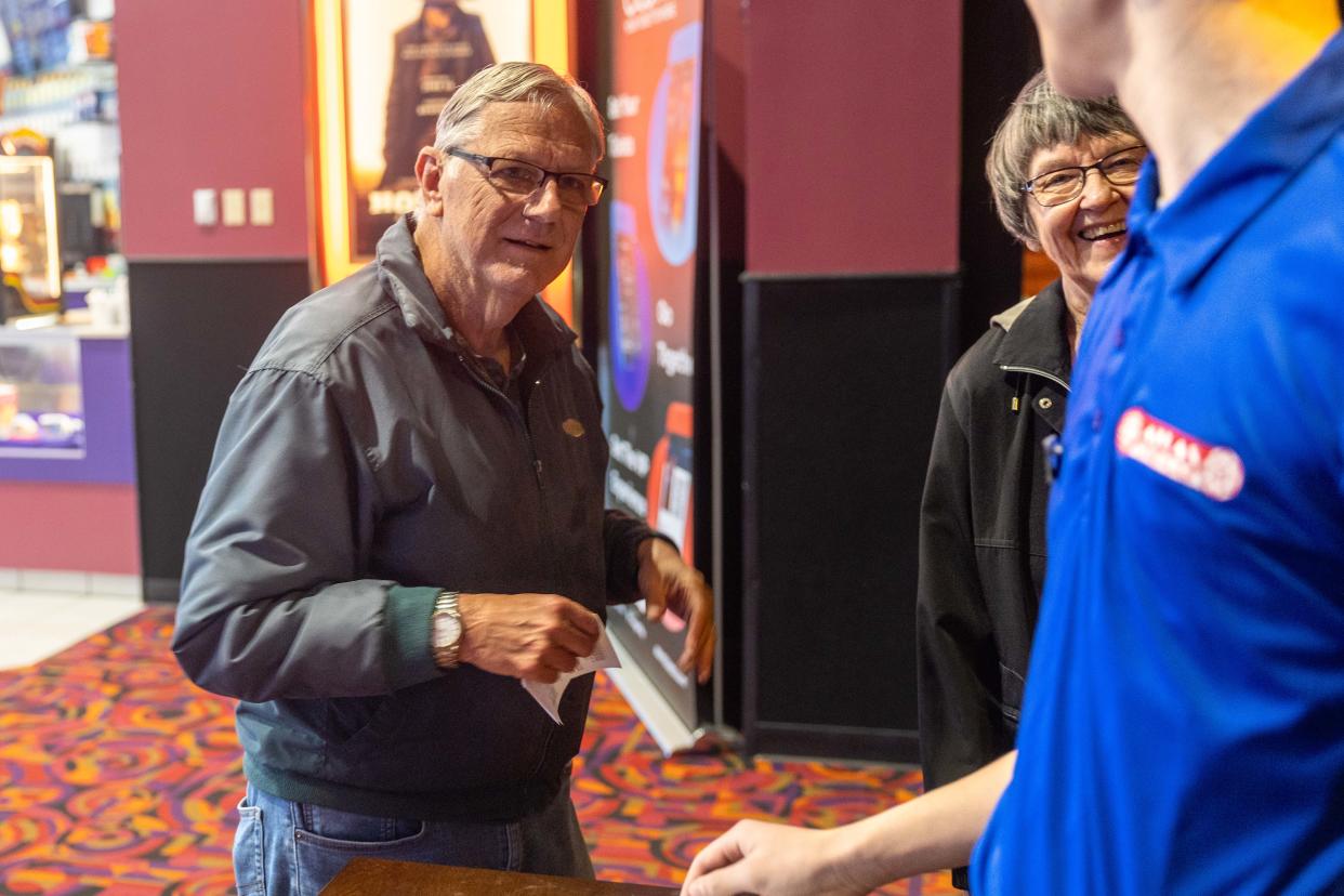 Aurora’s Jim and Elaine Weber talk to the usher as they head into their movie Saturday, April 13, 2024, in the newly opened Atlas Cinemas Barrington 10 in Aurora’s Barrington Town Center shopping center.