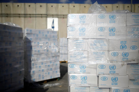 Boxes containing aid from the U.N. Relief and Works Agency (UNRWA) are seen ahead of their transfer to the Gaza Strip, inside the Kerem Shalom border crossing terminal between Israel and Gaza Strip January 16, 2018. REUTERS/Amir Cohen