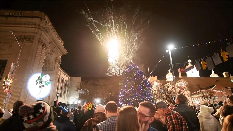 A couple kisses as the white rose drops and fireworks fill the sky at Continental Square in York on New Year's.