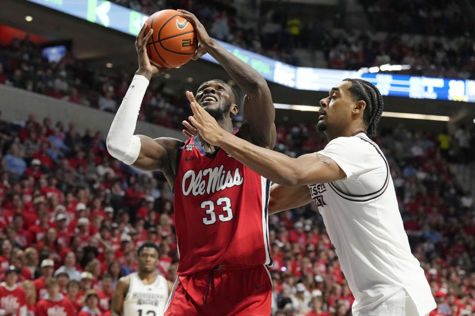 Mississippi forward Moussa Cisse (33) attempts a shot at the basket while Mississippi State forward Tolu Smith (1) defends during the second half of an NCAA college basketball game, Tuesday, Jan. 30, 2024, in Oxford, Miss. Mississippi won 86-82. (AP Photo/Rogelio V. Solis)