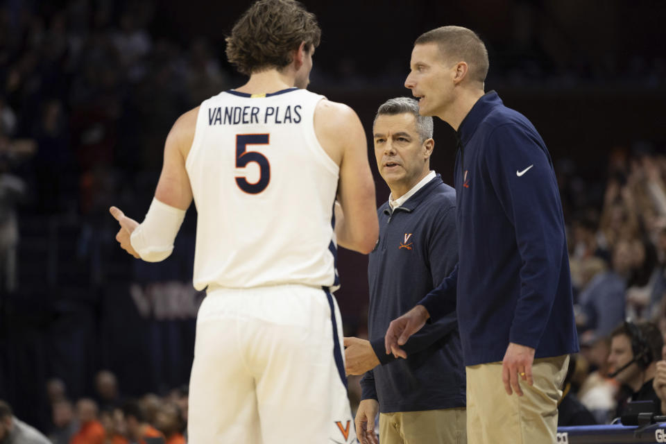 Virginia head coach Tony Bennett, right, speaks to Ben Vander Plas (5) during the first half of an NCAA college basketball game against Syracuse in Charlottesville, Va., Saturday, Jan. 7, 2023. (AP Photo/Mike Kropf)