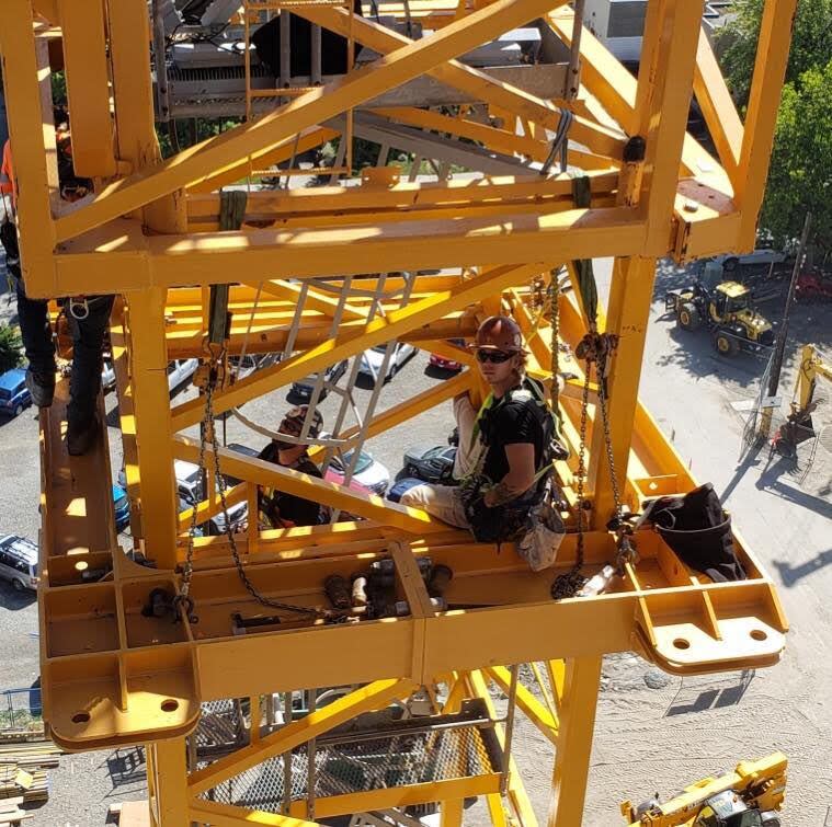 Cailen Vilness is shown sitting in a construction crane in a family photo. Vilness, 23, died in a crane collapse in Kelowna, B.C., on July 12, 2021.