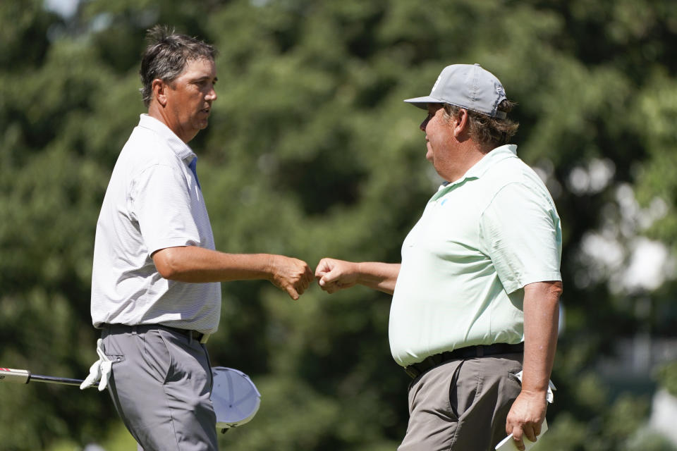 Shane Bertsch fist bumps Tim Herron, right, after making a birdie putt on the 18th green during the second round of the PGA Tour Champions Principal Charity Classic golf tournament, Saturday, June 5, 2021, in Des Moines, Iowa. (AP Photo/Charlie Neibergall)