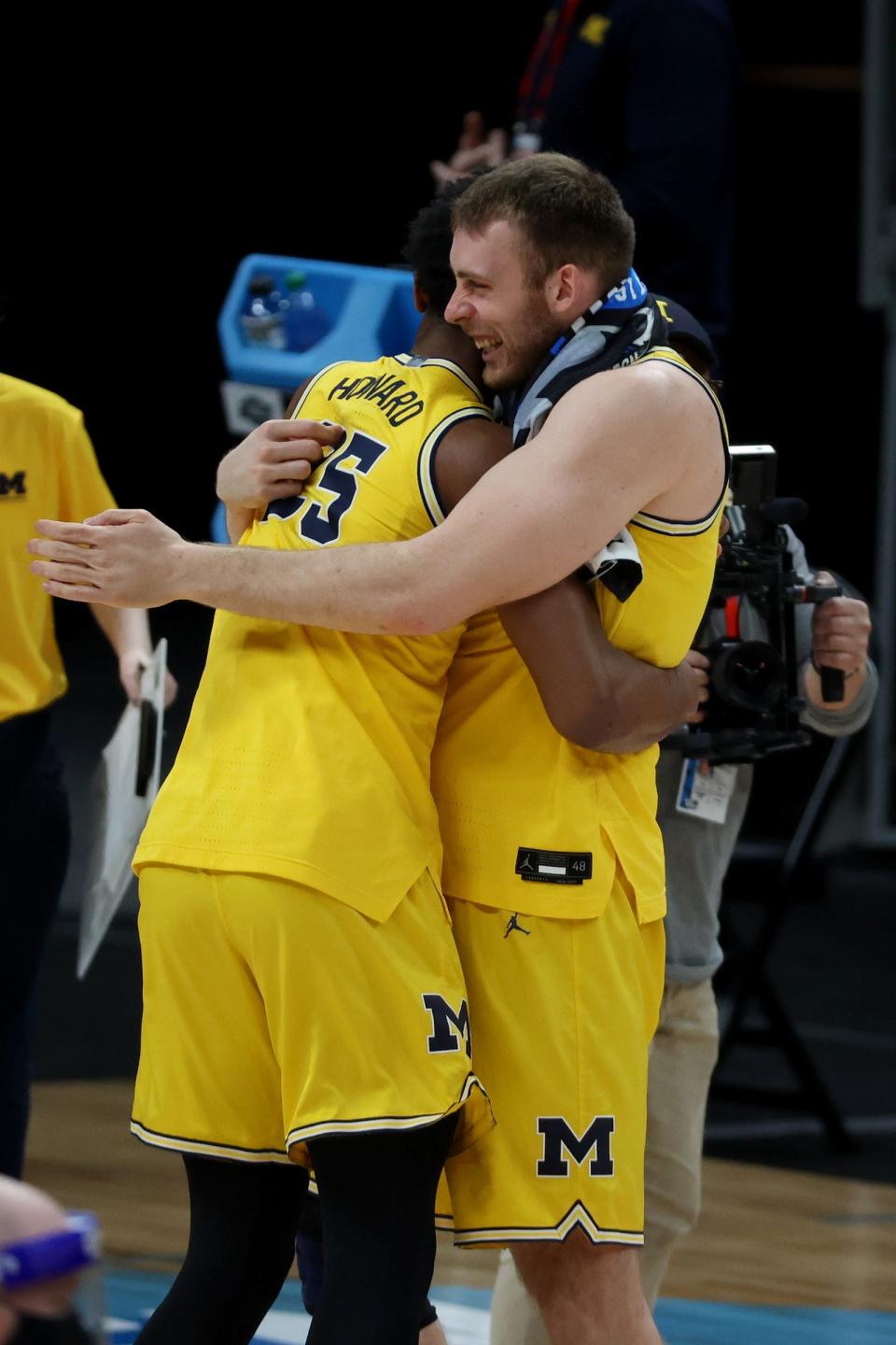 Michigan guard Jace Howard and forward Austin Davis celebrate after the 76-58 win over Florida State during the Sweet 16 game on Sunday, March 28, 2021, in Indianapolis.,