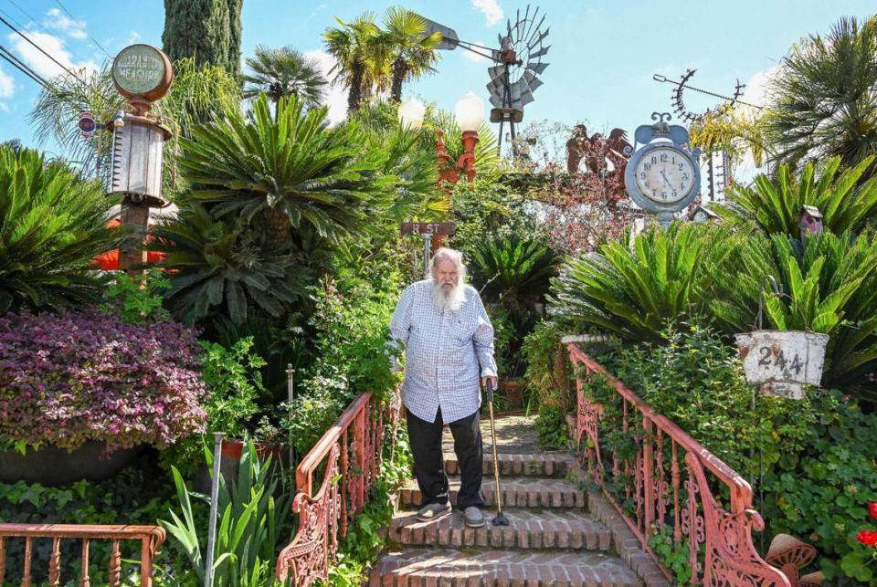 Jim Williams, surrounded by sago palms, old gas pumps, signs, clocks and an old windmill among other collected items and creations, stands on the brick steps leading to the entry of his home in the Fresno High area which he calls “Palazzo Del Sogni,” or Palace of Dreams. CRAIG KOHLRUSS/ckohlruss@fresnobee.com