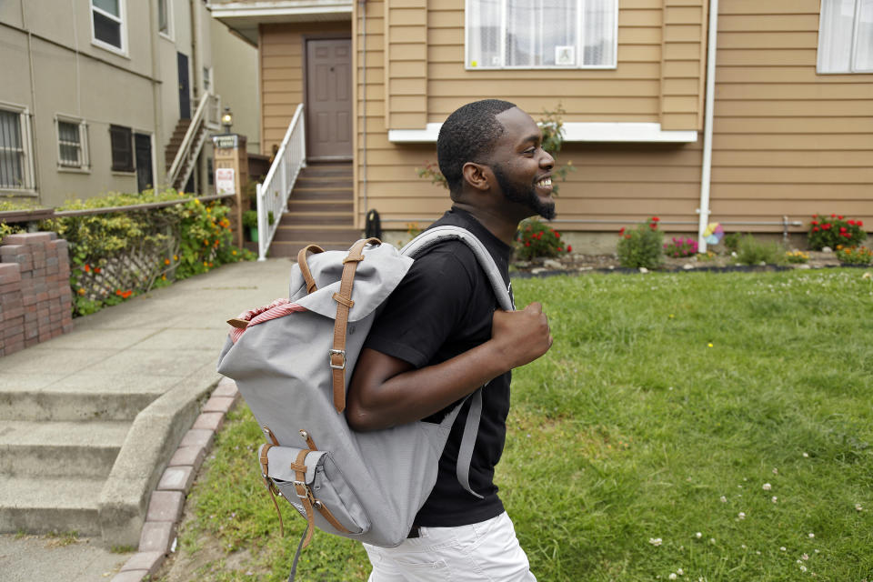 FILE - This May 11, 2017, file photo shows Andre Shavers, who runs a marijuana delivery business, on a street in Oakland, Calif. California faced off in court Thursday, Aug. 6, 2020, against some of its own cities that want to overturn a government rule allowing home marijuana deliveries statewide, even into communities that banned commercial pot sales. (AP Photo/Eric Risberg, File)