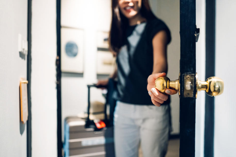 A person holding a door open