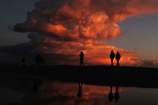 People walk on the beach at the sunset in French city of Nice on Monday. (Photo: VALERY HACHE/AFP via Getty Images)