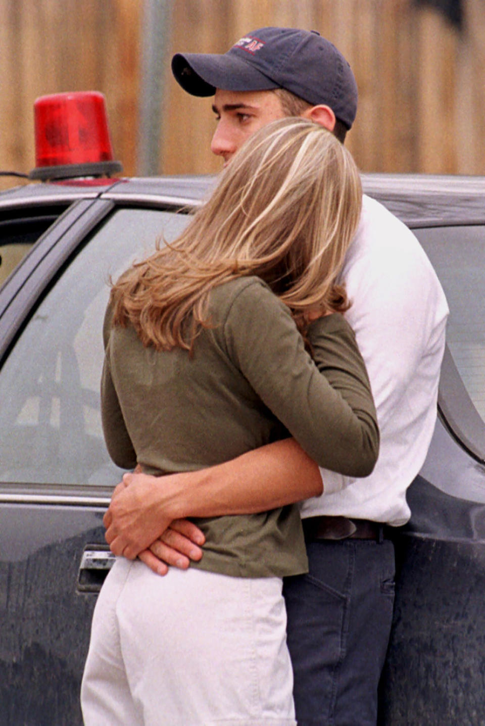 FILE - Ara Maranian, right, a junior at Columbine High School, hugs Megan Coxey, a sophomore at the school, after they were evacuated from the facility after two gunmen went on a shooting rampage Tuesday, April 20, 1999, in the southwest Denver suburb of Littleton, Colo. (AP Photo/David Zalubowski, File)