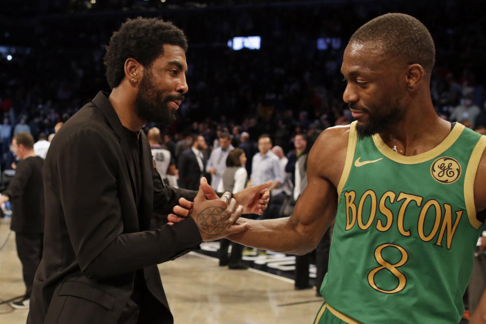 Brooklyn Nets guard Kyrie Irving greets Boston Celtics guard Kemba Walker (8) after their NBA basketball game Friday, Nov. 29, 2019, in New York. The Nets won 112-107. (AP Photo/Adam Hunger)