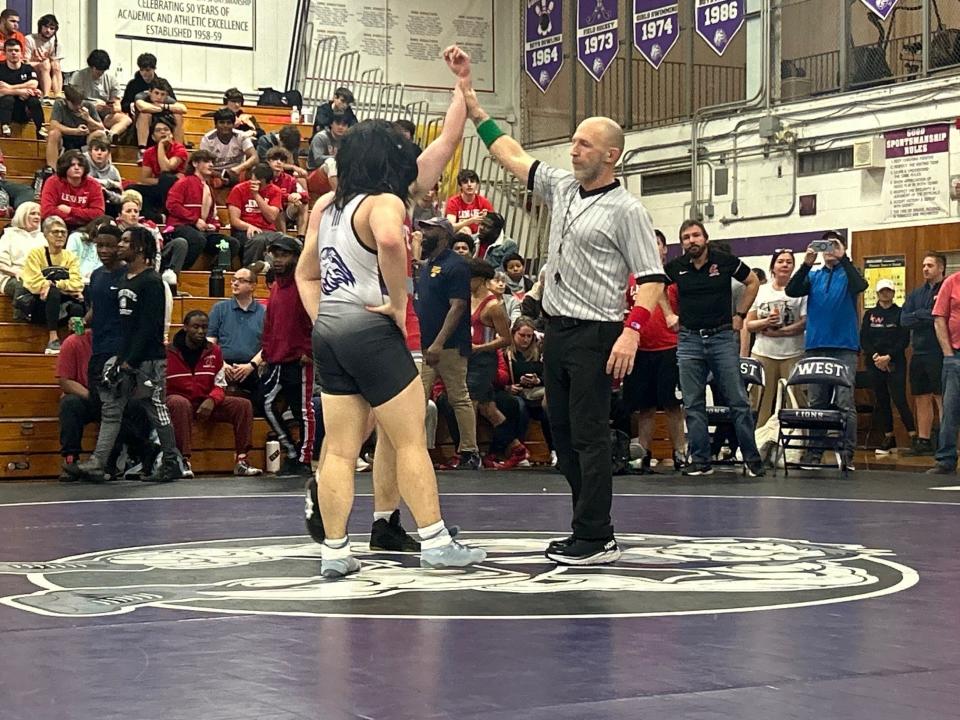 Mike Ahern works at a recent JV jamboree meet at Cherry Hill West High School on Saturday. After a standout career as a wrestler and a coach, Ahern is a first-year official.