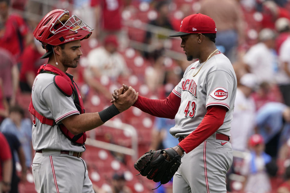Cincinnati Reds relief pitcher Alexis Diaz (43) and catcher Aramis Garcia celebrate a 7-6 victory over the St. Louis Cardinals following a baseball game Sunday, June 12, 2022, in St. Louis. (AP Photo/Jeff Roberson)