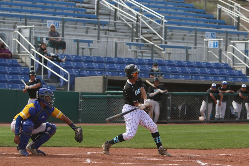 Navajo Prep's Michael Norwood singles to left field and drives in a run during the bottom of the first inning of a game against Zuni, Thursday, April 28, 2022 at Ricketts Park.