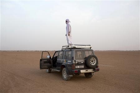 Toubou human smuggler Barka al Qatrun looks out for cars driven by his colleagues coming from Libya at a checkpoint outside Agadez March 14, 2014. REUTERS/Joe Penney