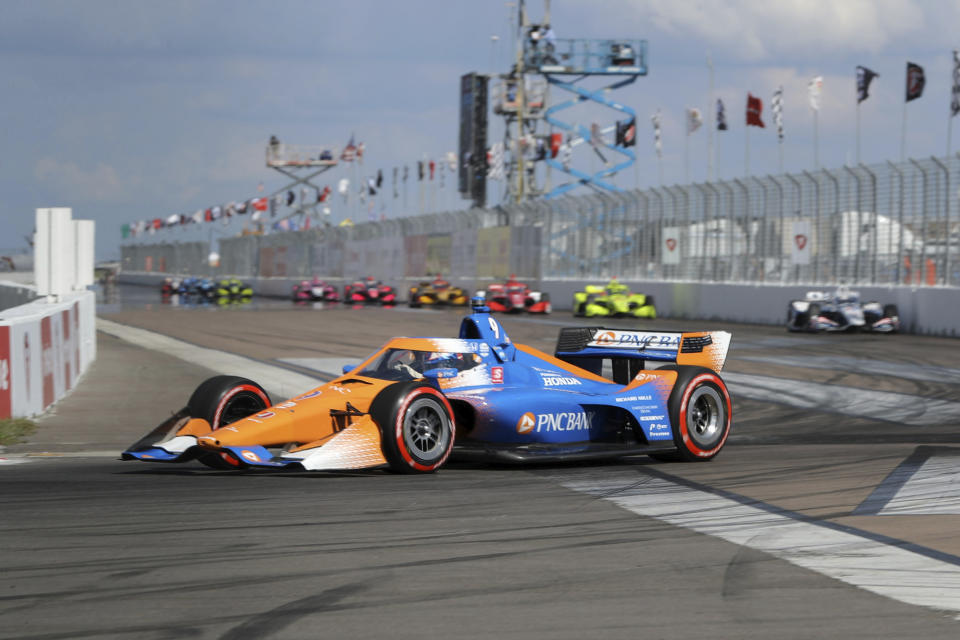 Scott Dixon leads a pack into Turn 1 during an IndyCar auto race Sunday, Oct. 25, 2020, in St. Petersburg, Fla. (AP Photo/Mike Carlson)