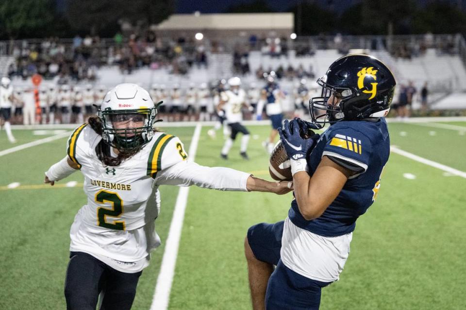 Gregori’s Landon Gutierrez makes a catch near the sideline as Livermore’s Tommy Pierson defends during the nonleague game at Gregori High School in Modesto, Calif., Friday, September 8, 2023.