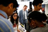 Britain's Chief Trade Negotiation Adviser Crawford Falconer watches students take part in a mock trade negotiation at Harris Westminster Sixth Form college in central London