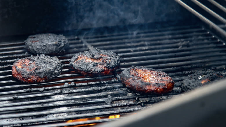 Burnt hamburgers on grill