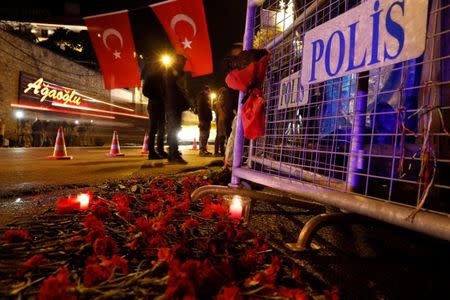 Flowers are placed in front of a police barrier near the entrance of Reina nightclub by the Bosphorus, which was attacked by a gunman, in Istanbul, Turkey, January 1, 2017. REUTERS/Umit Bektas