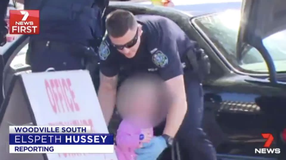 Police try to calm down two little girls as their parents are arrested. Source: 7 News