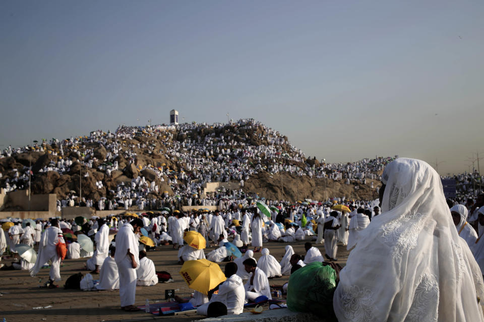 FILE - Muslim pilgrims pray on a rocky hill known as Mountain of Mercy, on the Plain of Arafat, during the annual hajj pilgrimage, near the holy city of Mecca, Saudi Arabia, on Sept. 11, 2016. Police in Mecca say they have arrested a Saudi man who helped an Israeli-Jewish reporter sneak into the city, defying a rule that only Muslims can enter the area that is home to Islam's holiest site. (AP Photo/Nariman El-Mofty, File)