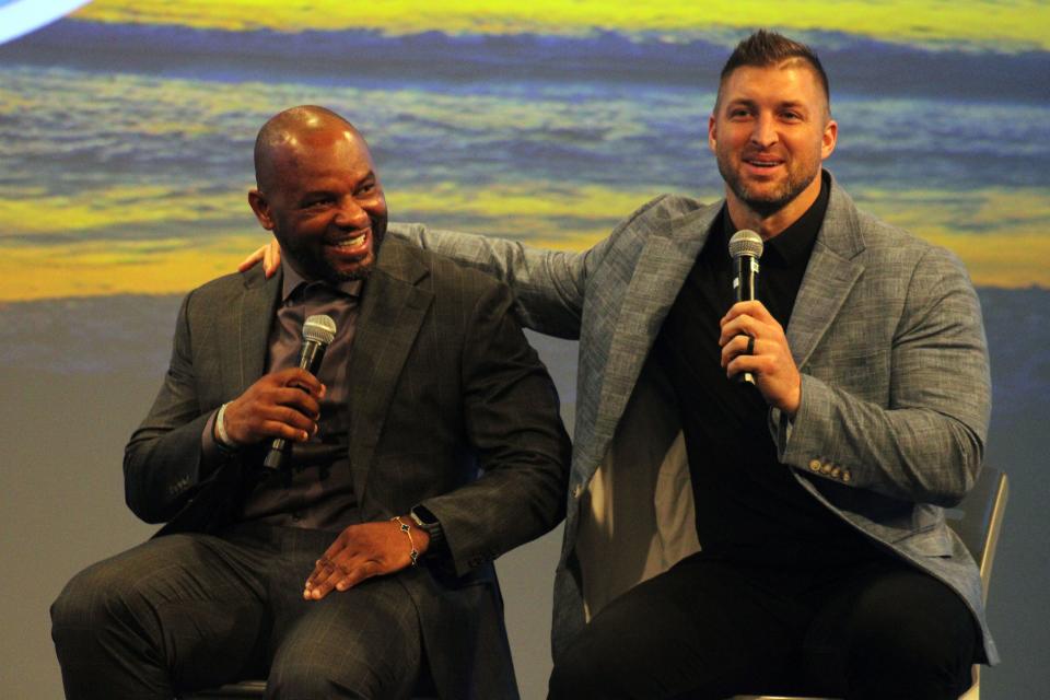 Former University of Florida football stars and JAXUSL co-owners Fred Taylor and Tim Tebow talk during the Sporting Jax announcement.