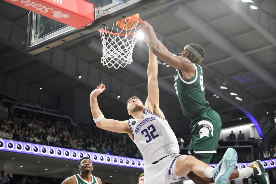 Michigan State Spartans forward Coen Carr (55) goes up for a dunk on Northwestern Wildcats forward Blake Preston (32) during the first half at Welsh-Ryan Arena in Evanston, Illinois, on Sunday, Jan. 7, 2024.