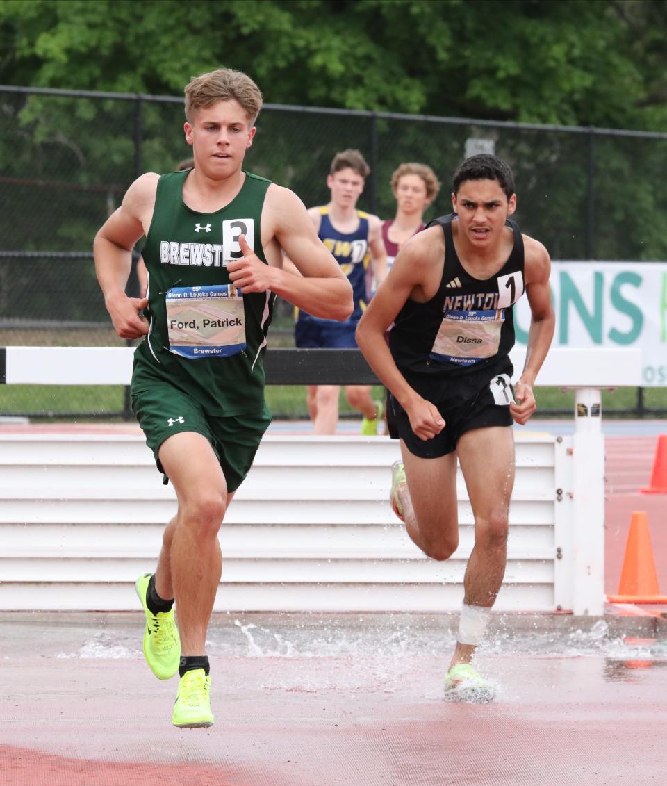 Patrick Ford from Brewster competes in the men's 3000 meter steeplechase as Soheib Dissa from Newtown follows close behind during the 55th annual Glenn D. Loucks Track & Field Games at White Plains High School, May 13, 2023. 