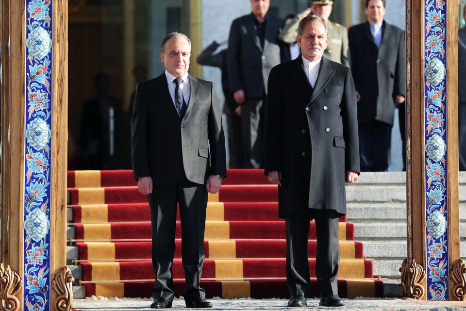 In this photo released by official website of the Office of the Iranian Vice President, Syrian Prime Minister Imad Khamis, left, welcomed by Iranian Senior Vice-President Eshaq Jahangiri during his official arrival ceremony at the Saadabad Palace in Tehran, Iran, Monday, Jan. 13, 2020. (Office of the Iranian Vice President via AP)