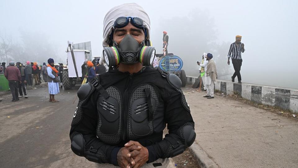 A demonstrator wearing a gas mask during a protest by farmers