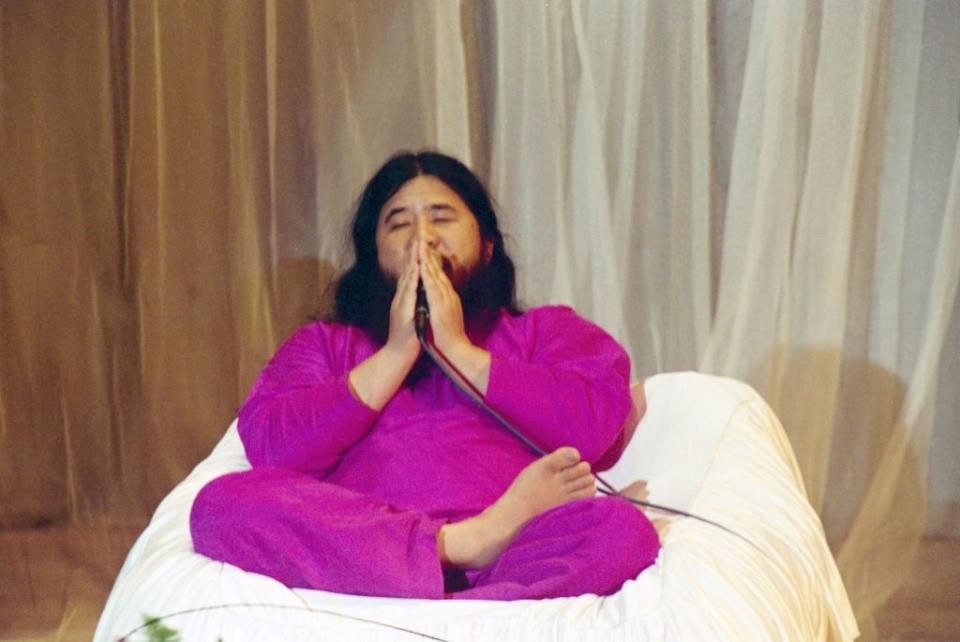 Shoko Asahara, leader of the cult group Aum Shinrikyo sitting with his legs crossed