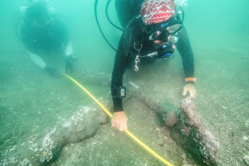 Marine archaeologists take measurements of a 16th century anchor that may represent ground tackle used during the scuttling of Hernan Cortes' fleet of 1519, at the littoral of Veracruz state