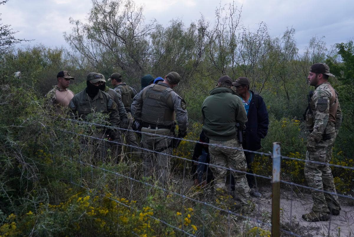 Department of Public Safety Special Operations agents escort a group of migrants through private property as part of Operation Lone Star after catching them in Kinney County near Brackettville, Texas on Nov. 9, 2021. The owner of the property did not sign the affidavit to allow DPS to arrest undocumented migrants in their property, so they will be processed by Border Patrol.
Verónica G. Cárdenas for ProPublica/The Texas Tribune