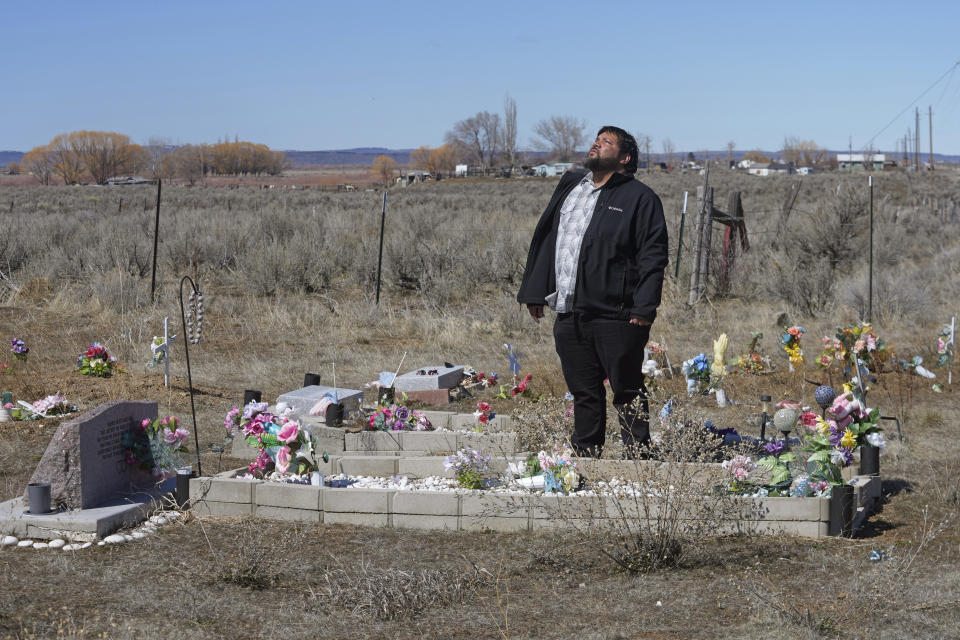 Shoshone-Paiute tribal member Michael Hanchor visits his mother’s grave, March 15, 2024, in Owyhee, Nev., on the Duck Valley Indian Reservation that straddles the Nevada-Idaho border. (AP Photo/Rick Bowmer)