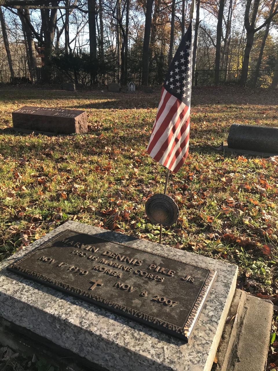 U.S. flags are placed at all 13 veterans' markers by Sue Faulk, whose dad is one of them.