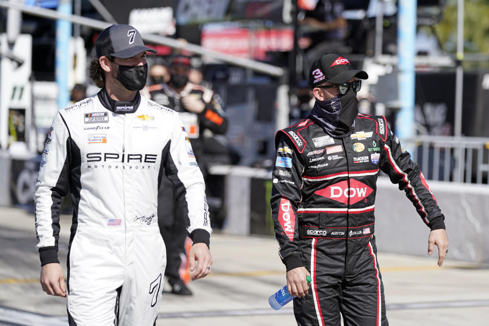 Corey LaJoie, left, and Austin Dillon walks down pit road before the start of the NASCAR Cup Series road-course auto race at Daytona International Speedway, Sunday, Feb. 21, 2021, in Daytona Beach, Fla. (AP Photo/John Raoux)