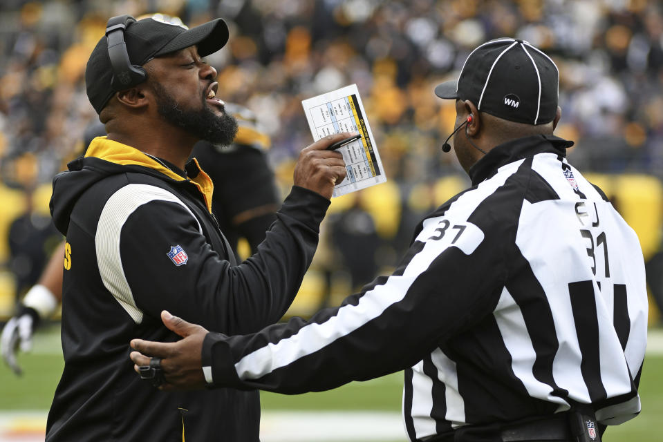 Pittsburgh Steelers head coach Mike Tomlin, left, talks with line judge Tripp Sutter (37) during the first half of an NFL football game against the Baltimore Ravens in Pittsburgh, Sunday, Dec. 11, 2022. (AP Photo/Fred Vuich)