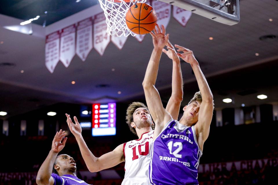 Oklahoma forward Sam Godwin (10) and Central Arkansas forward Tucker Anderson (12) fight for a rebound in the first half during an NCAA game between the Oklahoma Sooners and the Central Arknasaw Bears at the Lloyd Noble Center in Norman, Okla., on Thursday, Dec. 28, 2023.