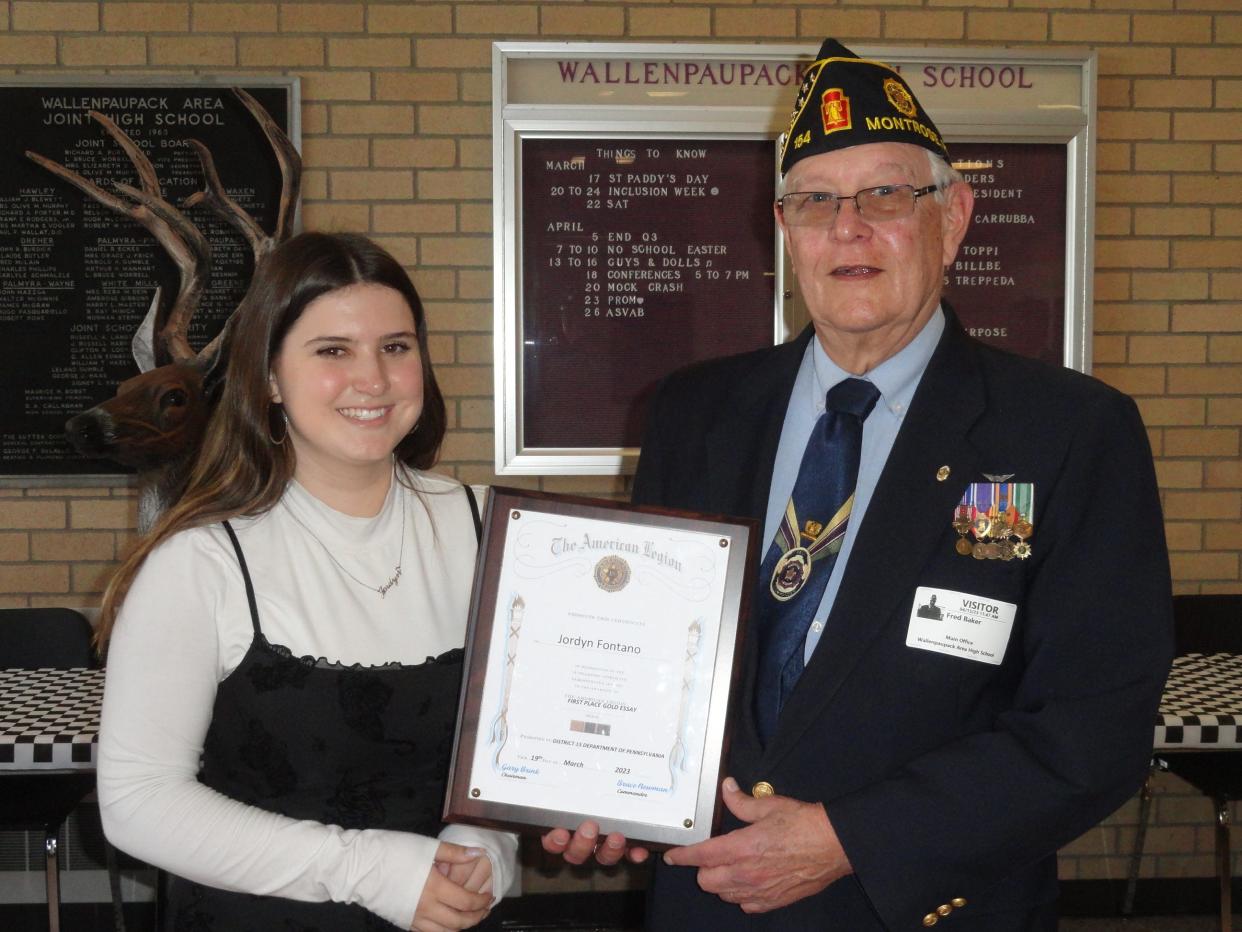 Jordyn Fontano, a junior at Wallenpaupack Area High School, took first place in the American Legion essay contest for District 15, covering 28 posts in Northeastern Pennsylvania. This is believed to be the first time a student's essay from Post 311 Hawley, had this achievement. Fred Baker, Post 311 Finance Officer, presents a plaque to Jordyn, April 12.