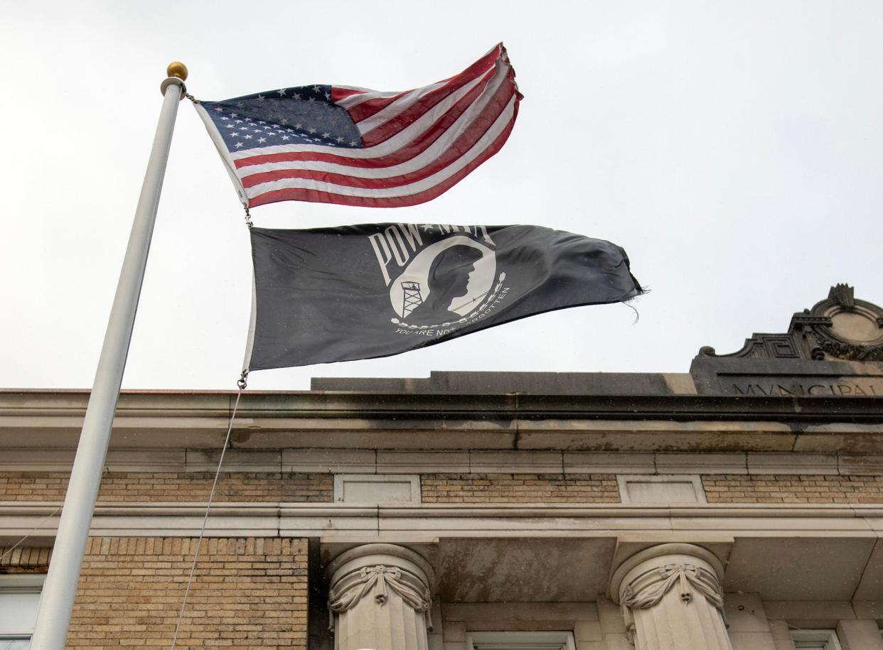 The American flag and the POW/MIA flag fly Wednesday in front of Leominster City Hall. The Commonwealth of Massachusetts flag is on a nearby pole.