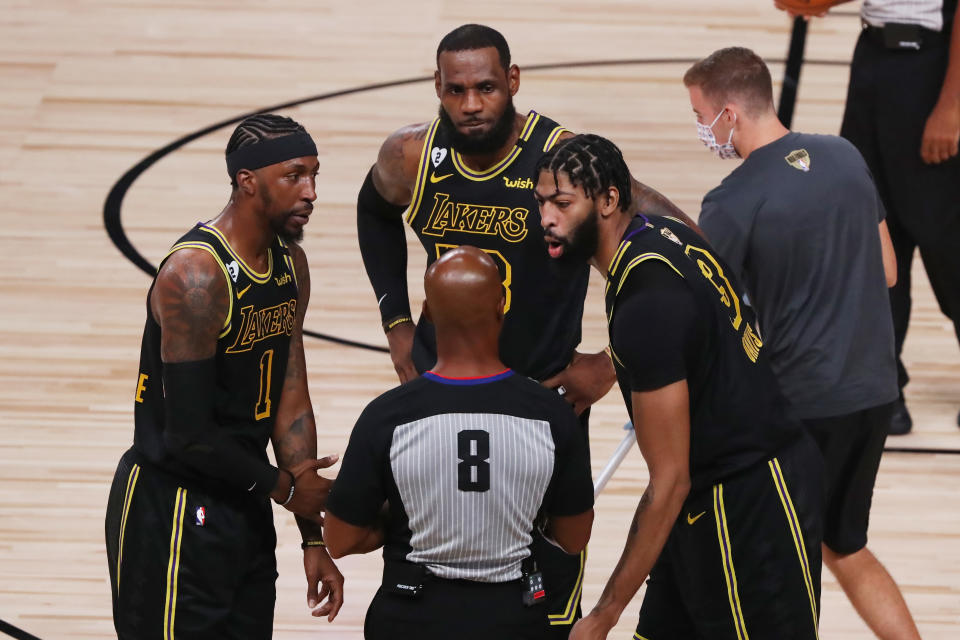 LAKE BUENA VISTA, FLORIDA - OCTOBER 09: LeBron James #23 of the Los Angeles Lakers, Kentavious Caldwell-Pope #1 of the Los Angeles Lakers and Anthony Davis #3 of the Los Angeles Lakers talk with referee Marc Davis #8 during the first quarter against the Miami Heat in Game Five of the 2020 NBA Finals at AdventHealth Arena at the ESPN Wide World Of Sports Complex on October 9, 2020 in Lake Buena Vista, Florida. NOTE TO USER: User expressly acknowledges and agrees that, by downloading and or using this photograph, User is consenting to the terms and conditions of the Getty Images License Agreement. (Photo by Sam Greenwood/Getty Images)