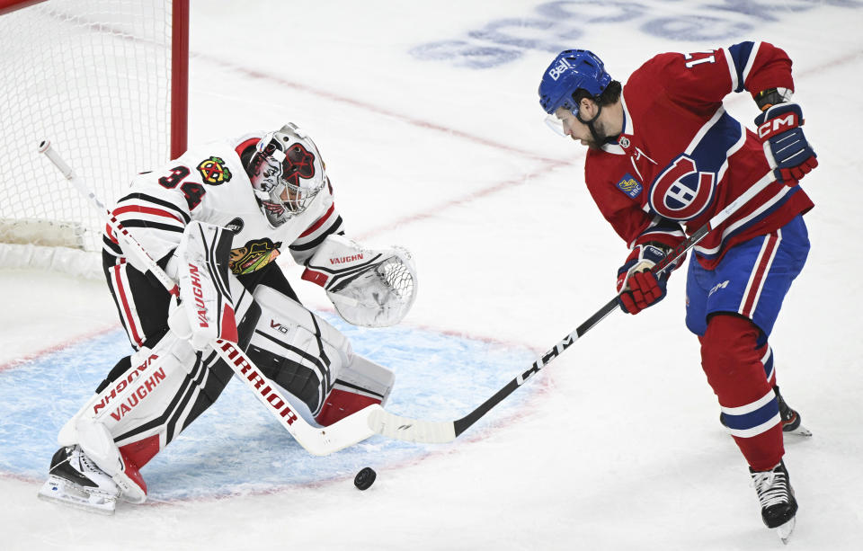 Montreal Canadiens' Josh Anderson (17) moves in on Chicago Blackhawks goaltender Petr Mrazek during the first period of an NHL hockey game in Montreal, Saturday, Oct. 14, 2023. (Graham Hughes/The Canadian Press via AP)