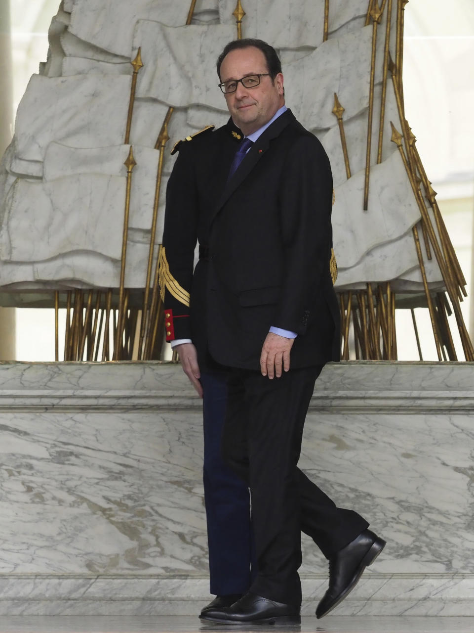 France's President Francois Hollande walks on the lobby of the Elysee Palace after the weekly cabinet meeting, in Paris, Wednesday, March 22, 2017. (AP Photo/Thibault Camus)