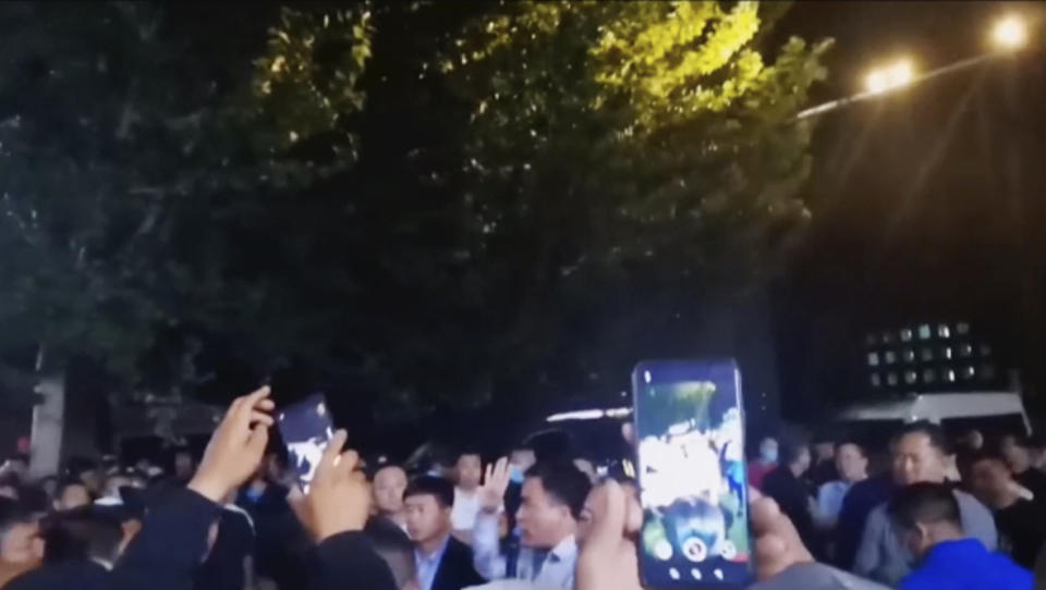 In this image made from video taken in August 2020, parents confront authorities outside a school in Tongliao in Northwestern China's Inner Mongolia region. Ethnic Mongolians, including students and parents, in China’s Inner Mongolia region are demonstrating their anger in rare public protests against a new bilingual education policy that they say is endangering the Mongolian language. (AP Photo)