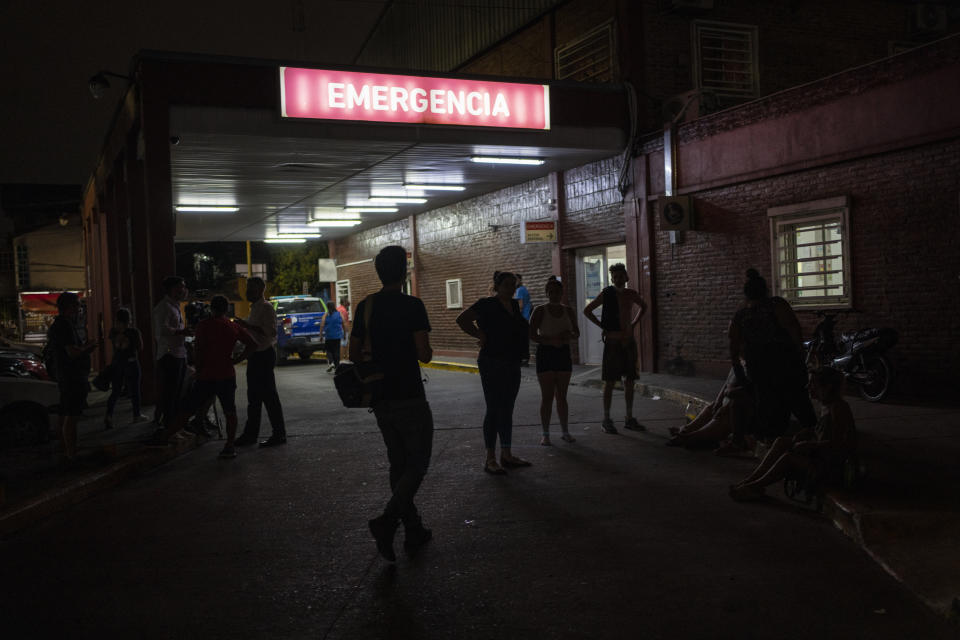 Relatives and friends of people who were poisoned with adulterated cocaine wait outside the emergency room of a hospital in the outskirts of Buenos Aires, Argentina, Wednesday, Feb. 2, 2022. According to local authorities, more than a dozen people have died and at least 50 seriously sickened after consuming adulterated cocaine. (AP Photo/Rodrigo Abd)