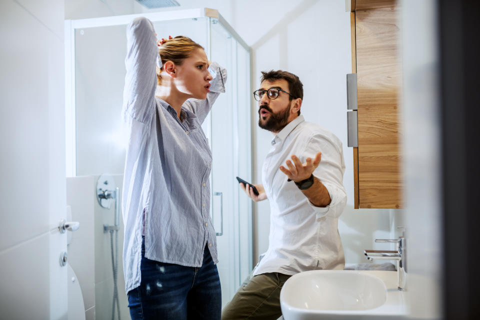 Couple getting ready for work and they are arguing. Bathroom interior, morning time.