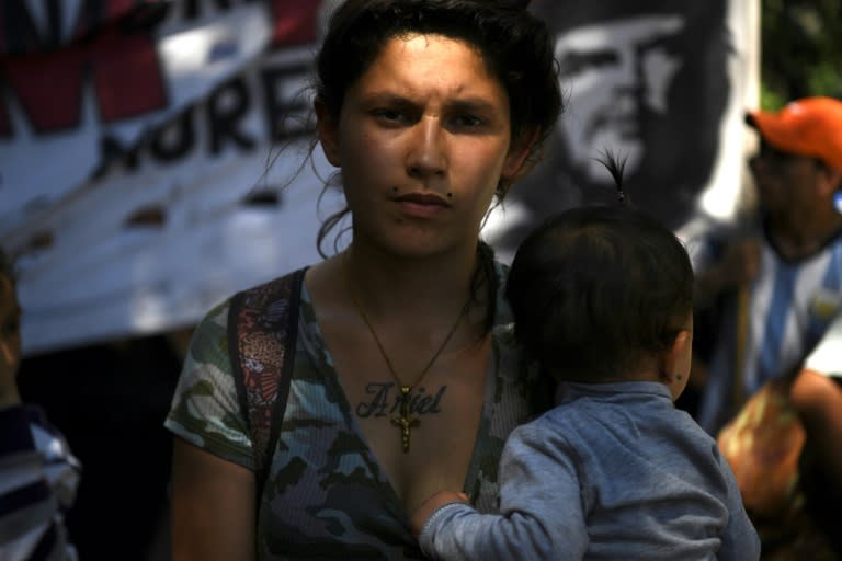 A woman with a baby takes part in a protest outside the Congress building while Argentine Senators discuss an austerity budget in Buenos Aires on November 14, 2018