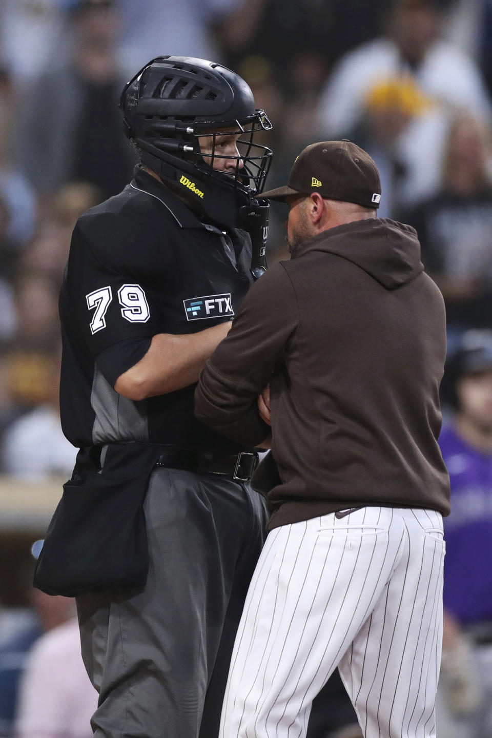 San Diego Padres manager Jayce Tingler, right, argues a called third strike with home plate umpire Manny Gonzalez (79) during the sixth inning of the team's baseball game against the Colorado Rockies on Saturday, July 31, 2021, in San Diego. Tingler was ejected. (AP Photo/Derrick Tuskan)