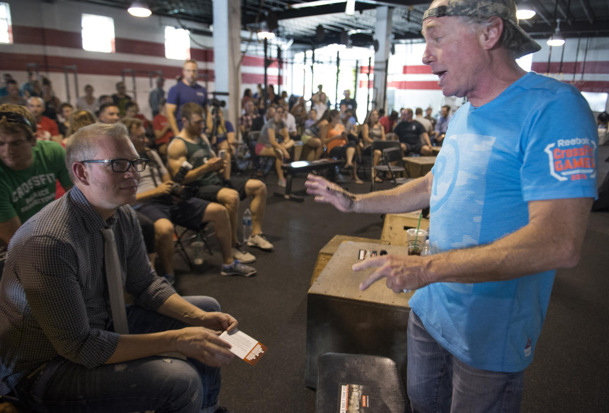 WASHINGTON, DC - JULY 31:    Crossfit Inc. founder and CEO Greg Glassman (R) talks to employees prior to a presentation at the Half street location in Washington, DC on July 31, 2015.  CrossFit is waging a war against new DC rules to regulate personal trainers, saying D.C. is a pawn in a commercial fight over personal fitness.  The city council is proposing licensure and regulation of personal trainers.  There is a fee involved.  If the law should pass, DC would be the first municipality in the nation to do so.  Crossfit Inc. officials are fighting the proposed law and say that they are trying to legislate something that they do not understand.   (Photo by Linda Davidson / The Washington Post via Getty Images)