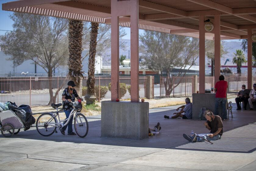 INDIO, CA - JULY 15: Homeless people and those in need of a free meal are no longer allowed to eat their free lunch in the lunchroom due to COVID-19 social distancing but can sit in the shade outside to escape he blazing sun and 109-degree heat at Martha's Village & Kitchen, one of the largest providers of homeless services in the Coachella Valley and Riverside County. The homeless and homeless shelters in Indio and Coachella Valley already face hardships this time of year when the area heats up to 100+ degree weather. Shelters already struggle to care for the homeless, but now COVID exacerbated their struggles. Photo taken Wednesday, July 15, 2020 in Indio, CA. (Allen J. Schaben / Los Angeles Times)